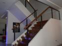 Glass Modern Stair Railing in Wrought Iron Frame